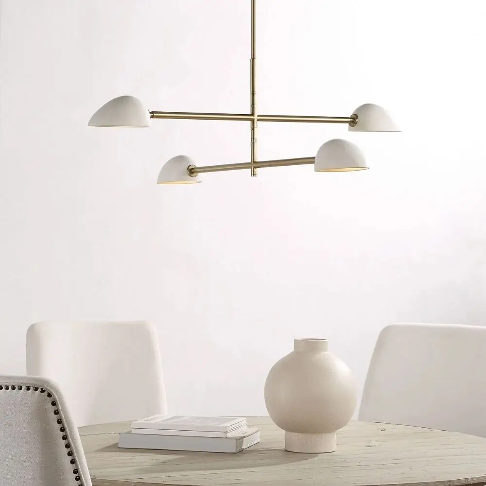 Modern brass chandelier with four angled white metal dome shades.