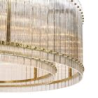 Sunpan Kore Large Clear Chandelier with cylindrical clear glass rods and a brushed gold frame.