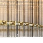 Sunpan Kore Large Clear Chandelier with cylindrical clear glass rods and a brushed gold frame.
