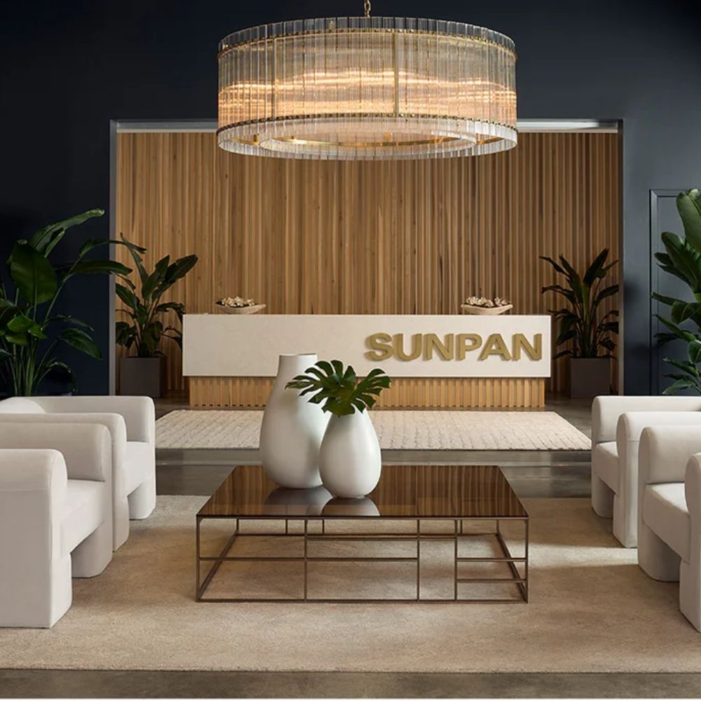 Sunpan Kore Large Clear Chandelier with cylindrical clear glass rods and a brushed gold frame.