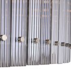 Sunpan Kore Large Smoke Grey Chandelier with cylindrical smoked glass rods and a brushed silver frame.