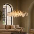 Uttermost Boreas Chandelier with cascading clear glass accents on a sculptural gold branch-like frame.