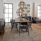 Uttermost Polaris Chandelier with a spherical black iron frame, brushed silver band, and starburst inner light design.