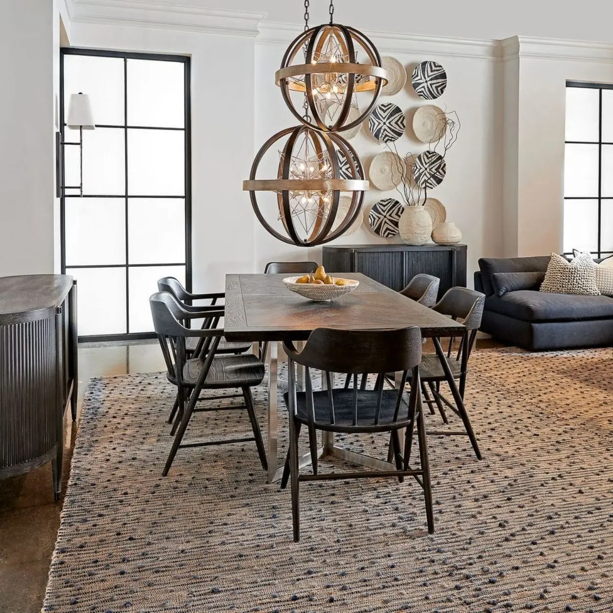 Uttermost Polaris Chandelier with a spherical black iron frame, brushed silver band, and starburst inner light design.