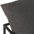 A modern lounge chair featuring a slim black metal frame and deep charcoal grey cushioned seat and backrest.
