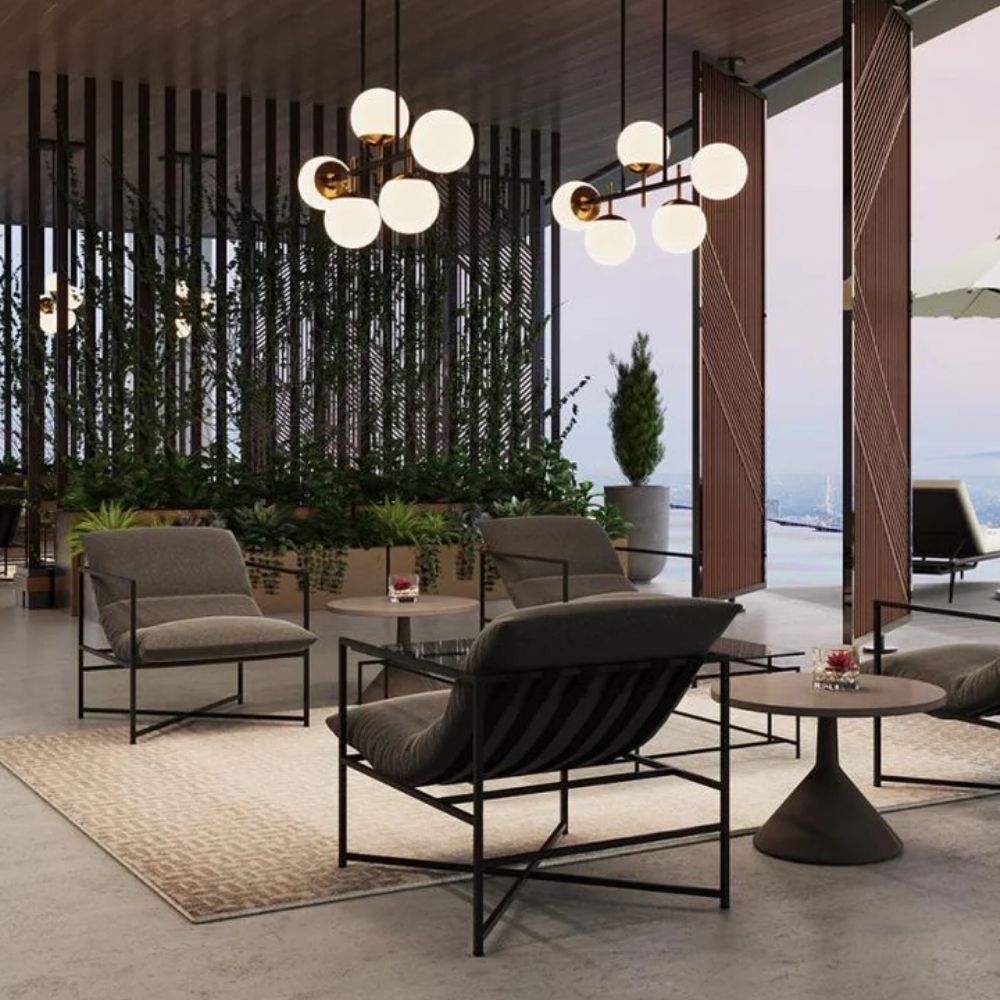A modern lounge chair featuring a slim black metal frame and deep charcoal grey cushioned seat and backrest.