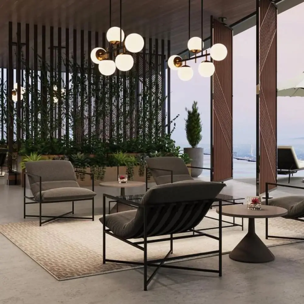 A modern lounge chair featuring a slim black metal frame and deep charcoal grey cushioned seat and backrest.