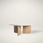Round coffee table with a white stone top and sculptural blonde wood base in an intersecting design.