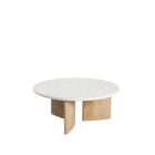 Round coffee table with a white stone top and sculptural blonde wood base in an intersecting design.