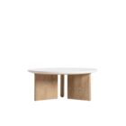 Round coffee table with a white stone top and sculptural blonde wood base in an intersecting design.