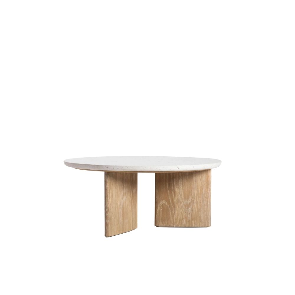 Round coffee table with a white stone top and sculptural blonde wood base in an intersecting design.