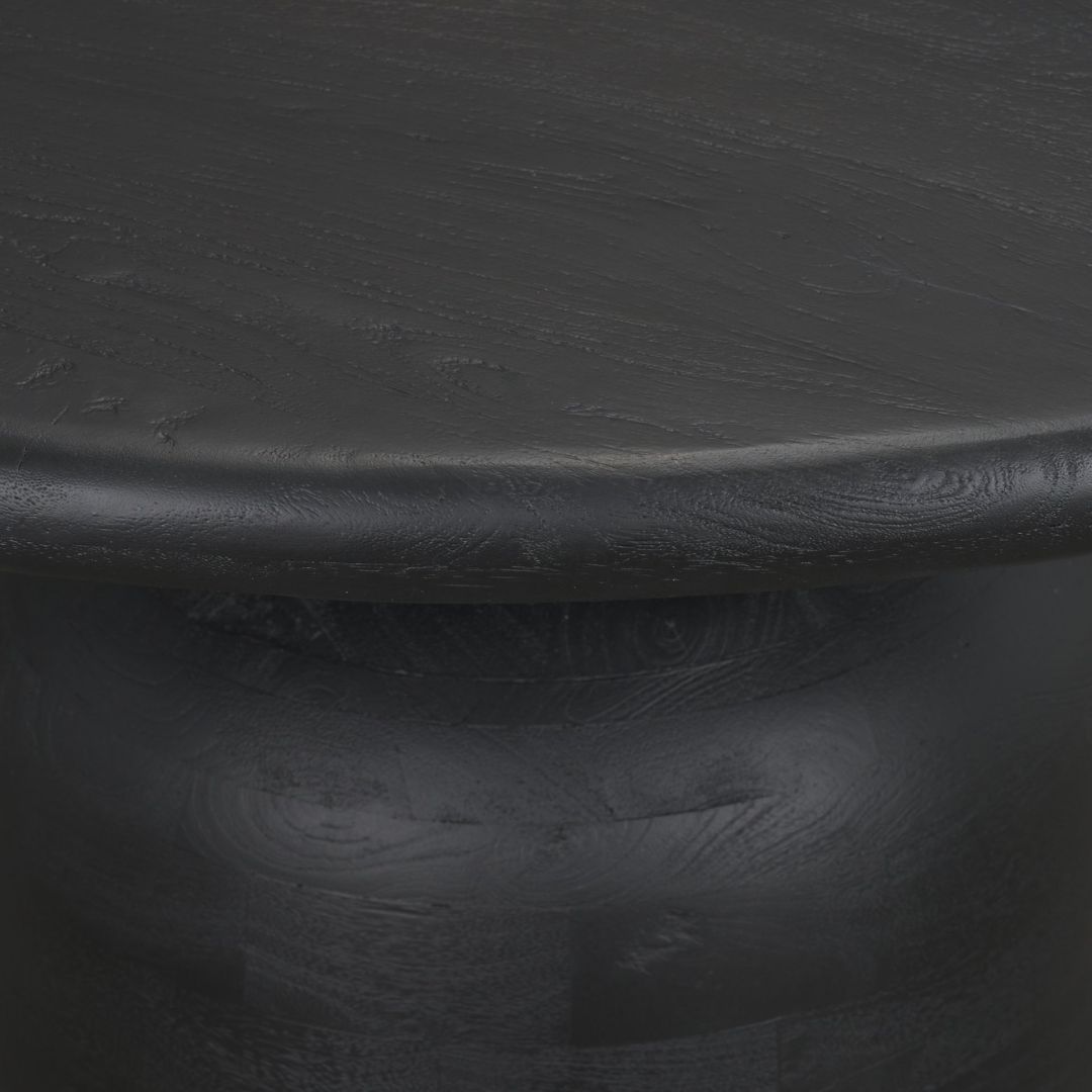 Modern round black dining table with sculptural pedestal base and smooth wood finish.