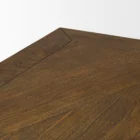 Rectangular wood dining table with a sculptural black pedestal base and rustic finish.