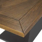 Rectangular wood dining table with a sculptural black pedestal base and rustic finish.