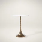 A round side table with a smooth white marble top and antique brass pedestal base, featuring a modern yet timeless silhouette.