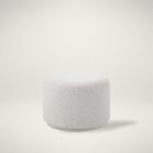 Renwil Audrina Ottoman with round silhouette upholstered in soft white textured fabric.
