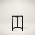 Renwil Avila Accent Table with round black marble top and minimalist three-leg black iron frame.