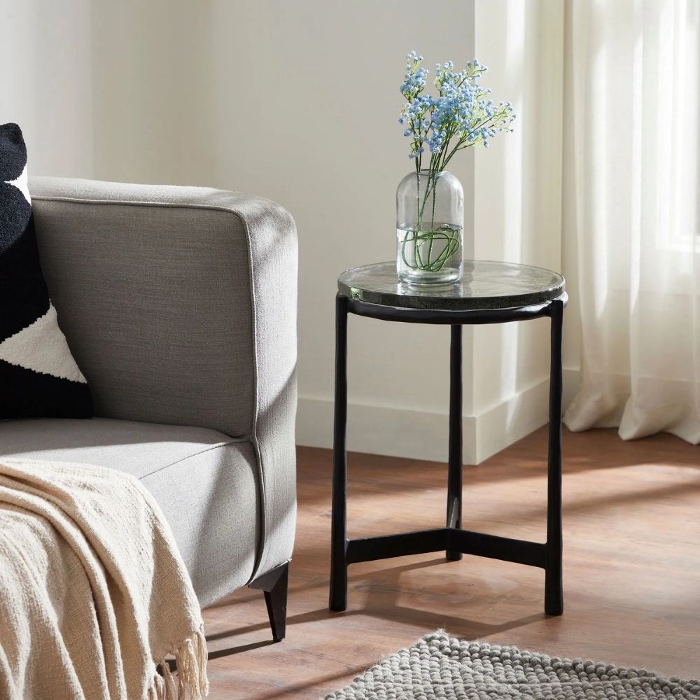 Renwil Avila Accent Table with round black marble top and minimalist three-leg black iron frame.