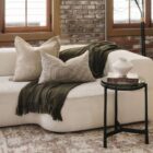 Renwil Avila Accent Table with round black marble top and minimalist three-leg black iron frame.
