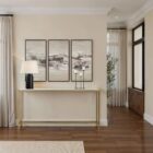 Slim console table with a white marble top and gold metal frame.