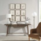A set of nine framed botanical prints featuring delicate floral illustrations in muted tones, each with a natural wood frame arranged in a grid layout.