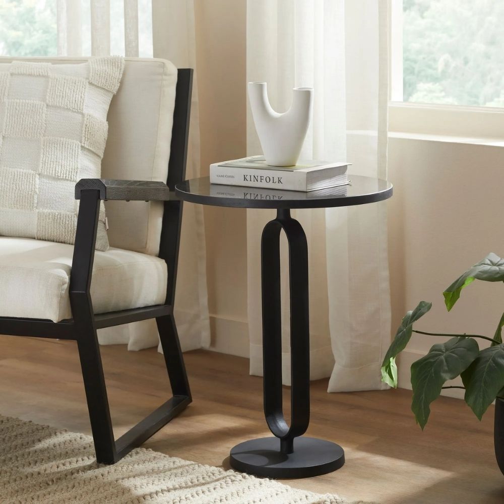 Renwil Eryx Accent Table with round black top and open geometric pedestal base in matte black metal.