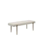 A minimalist upholstered bench in ivory boucle fabric with slim antique brass-finished tapered legs.