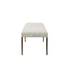 A minimalist upholstered bench in ivory boucle fabric with slim antique brass-finished tapered legs.