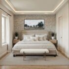 A minimalist upholstered bench in ivory boucle fabric with slim antique brass-finished tapered legs.