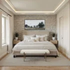 A minimalist upholstered bench in ivory boucle fabric with slim antique brass-finished tapered legs.
