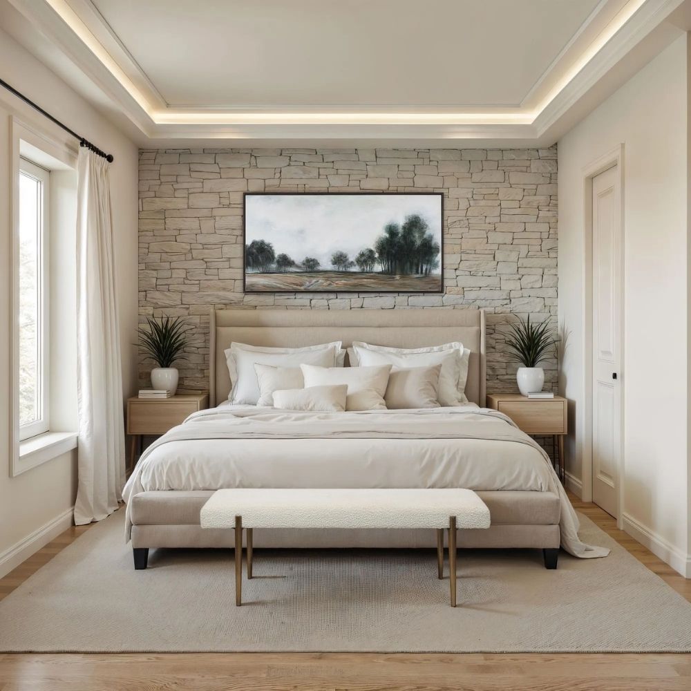 A minimalist upholstered bench in ivory boucle fabric with slim antique brass-finished tapered legs.