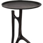 A sculptural black metal side table with a round top and organic tripod-style base featuring asymmetrical, branch-like legs.