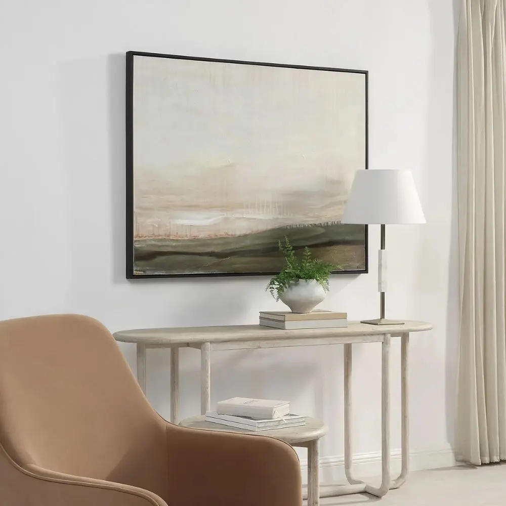 A contemporary landscape wall art piece featuring soft neutral tones of beige, cream, and earthy greens, framed in a slim black frame.