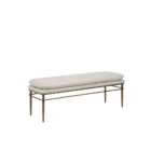 A modern upholstered bench with a slim ivory cushion and sleek antique brass-finished metal frame with tapered legs