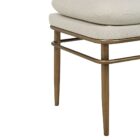 A modern upholstered bench with a slim ivory cushion and sleek antique brass-finished metal frame with tapered legs