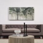 A nature-inspired wall art piece depicting tall trees with dark green foliage fading into a misty, neutral-toned background.
