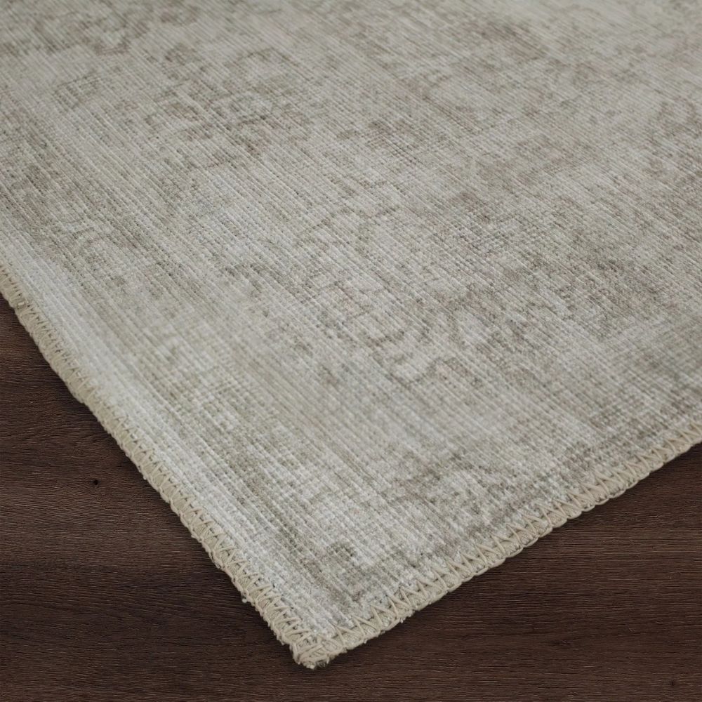 Light grey distressed rug with subtle tonal pattern and vintage-inspired texture.