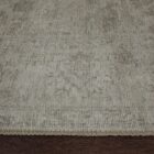 Light grey distressed rug with subtle tonal pattern and vintage-inspired texture.