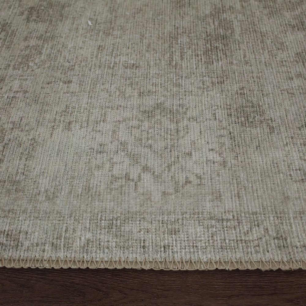 Light grey distressed rug with subtle tonal pattern and vintage-inspired texture.