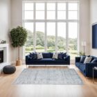 Light blue and ivory distressed rug with vintage-inspired medallion and border design.