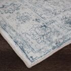 Light blue and ivory distressed rug with vintage-inspired medallion and border design.