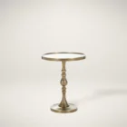 A round brass side table with a sculpted pedestal base and raised edge, featuring an antique finish and elegant silhouette.