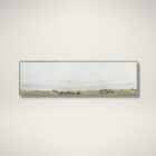 A panoramic landscape wall art piece featuring soft textured strokes of green fields beneath a wide expanse of pale sky, framed in a slim border.