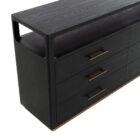 A modern black six-drawer dresser with slim brass handles, open top shelf, and a brass base accent.