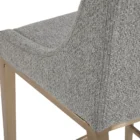 Modern counter stool with grey textured fabric seat and back, slim bronze-finished metal legs, and built-in footrest.