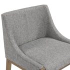 Modern counter stool with grey textured fabric seat and back, slim bronze-finished metal legs, and built-in footrest.