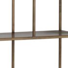 Tall narrow bookcase with slim gold metal frame and staggered open shelving.