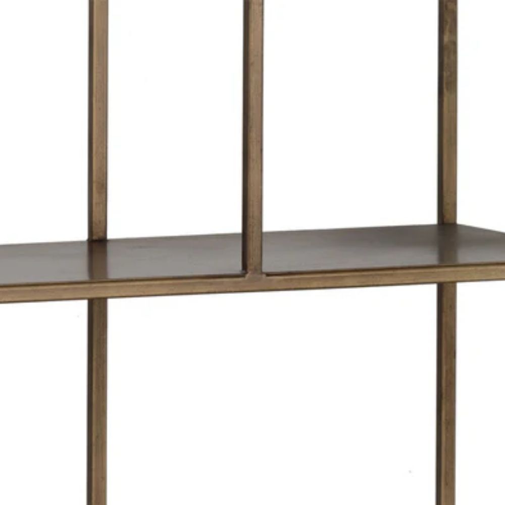 Tall narrow bookcase with slim gold metal frame and staggered open shelving.