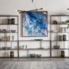 Tall narrow bookcase with slim gold metal frame and staggered open shelving.