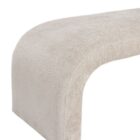 Curved taupe upholstered bench with seamless modern silhouette and low-profile design.